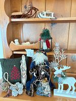 Overall view of shelf with multiple Christmas décor items