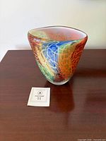 Front view of multicolor Badash art glass vase