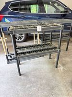 Front view of two resin shelving units showing overall structure and size relative to vehicle