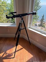 Full view of Canadian Geographic GEO55 telescope on tripod near window