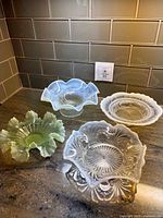 Group shot of four opalescent bowls in different colors