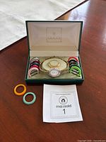 Complete set in box showing watch, bezels, card