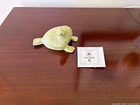 Full view of stone seal on table with size reference card