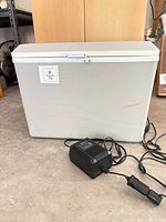 Front view of Koolatron P75 cooler with adapter in foreground