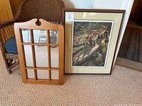 Overall view of both the framed print and wall mirror standing side by side