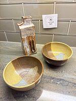 Group shot: two bowls and rectangular vase on countertop
