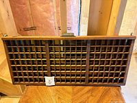 Full view of wooden printer's tray front showing compartments