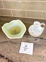 Opalescent ribbed spiral bowl beside bubbled glass vase