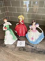 All three Royal Doulton figurines grouped together on countertop