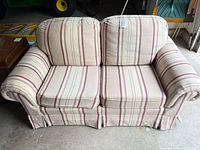 Front view of Sklar-Peppler striped cotton loveseat showing overall design and cushions