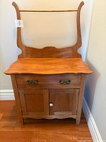 Front view of washstand showing drawer, doors, backsplash