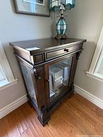 Full view of cabinet showing drawers, glazed door, overall style