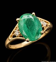 Full view of ring showing emerald, diamonds and gold band