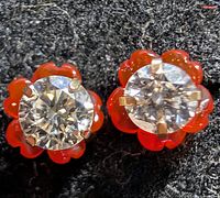 Front view of both earrings showing diamonds and red jackets