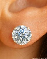 Close-up of one diamond stud in ear showing 4-prong 14K setting
