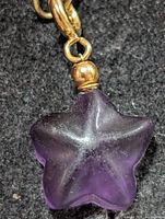 Front view showing purple fluorite star and gold-tone bead