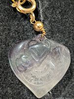 Front view of carved fluorite heart pendant with gold-tone fittings
