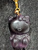 Front view of purple fluorite cat pendant