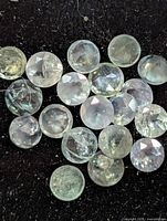 Group of loose round alexandrite stones on black background