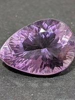 Front view of pear-cut amethyst showing colour and faceting