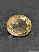 Front view of round citrine showing facets and colour