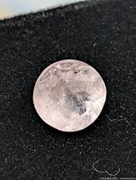 Close-up of pale pink round faceted morganite