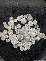 Close-up view of loose diamonds on black background