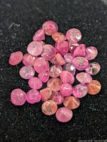 Close-up of loose rubies spread on black background