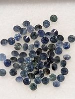 Close up view showing multiple small round blue sapphires