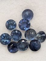 Group of round blue sapphires on display pad