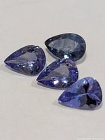 Four pear-cut tanzanites close-up