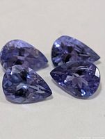 Four pear-cut tanzanite gemstones close-up