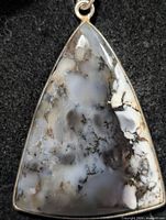 Front view of triangular dendritic agate pendant showing stone pattern and silver bezel