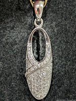 Front view of silver pavé CZ shoe pendant with bail
