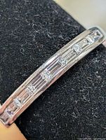 Macro view of CZ stones channel-set in silver band