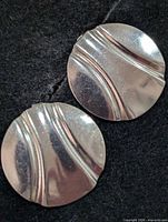 Front view of both earrings showing wave-groove design