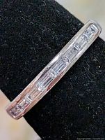 Top view of silver band with channel-set CZ stones