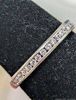 Close-up of CZ stones set in silver band