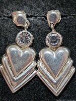 Front view of both earrings showing heart dangles and clear stones