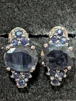 front view showing oval centre sapphires and round accents
