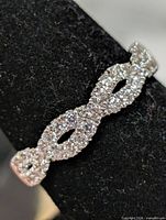 front view of one earring displaying infinity twist and CZ setting