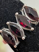 Front view of ring showing three marquise garnets
