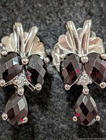 Front view of earrings showing garnets and fan design