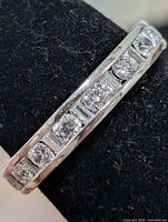 Close-up of ring front showing channel-set cubic zirconia stones