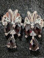 Front view showing garnet arrangement and silver fan tops