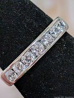 Close-up of seven CZ stones set in silver band
