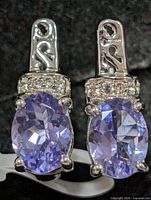 Front view of earrings showing tanzanite stones and accent stones