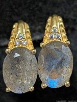 Front view showing labradorite cabochons, clear accent stones and yellow tone setting