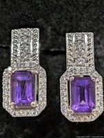 Front view showing amethyst center stones and CZ borders