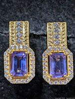 Front view showing amethyst centres, CZ halo, textured setting